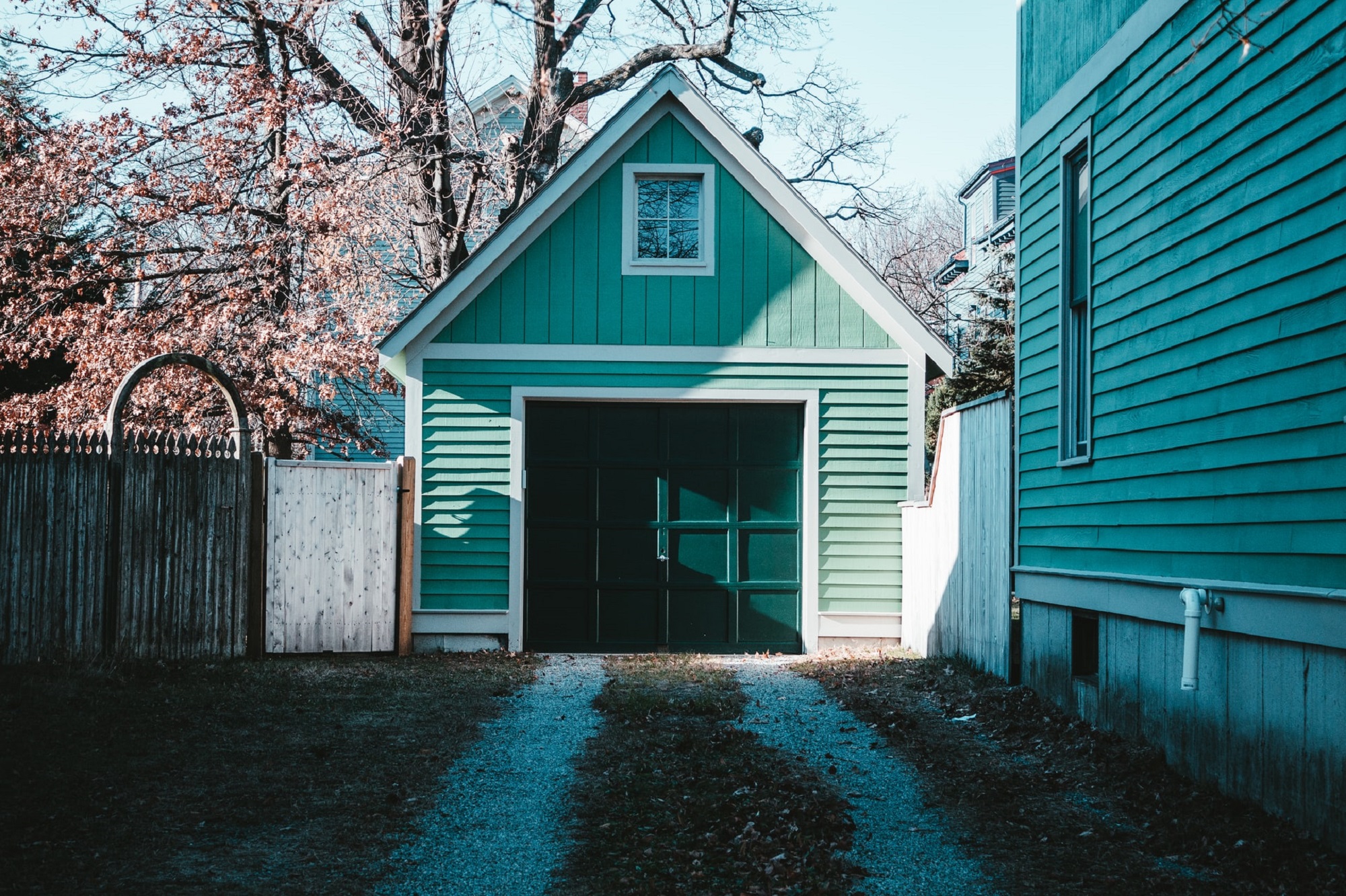 Green garage door next to a Colorado house