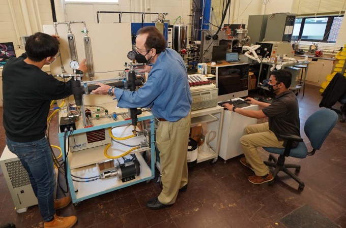 Purdue engineers testing an electric vehicle faster charging cable with liquid cooling technology for Ford