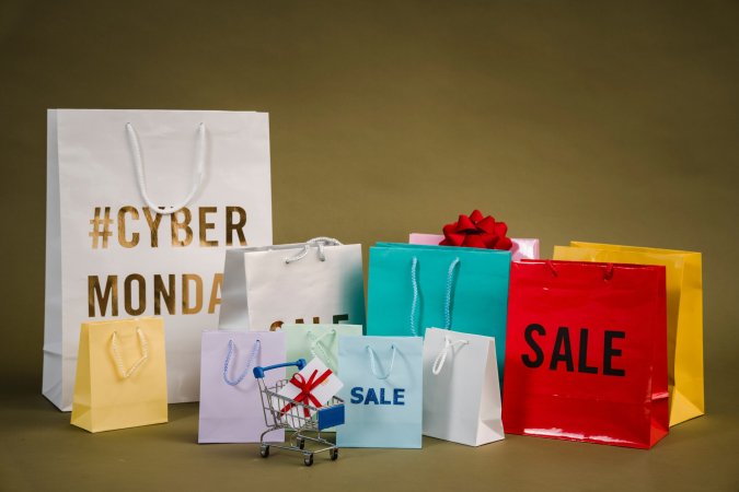 Shopping bags and gifts with cyber monday and sale stickers.