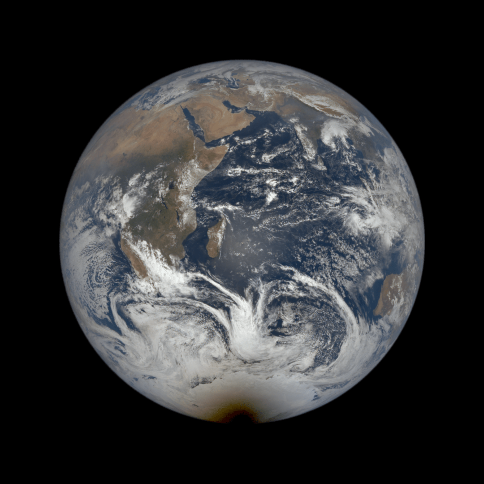 planet earth with a rounded black shadow creeping over its southern pole