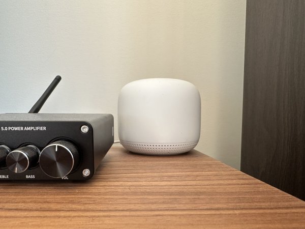  Google Nest Wi-Fi sitting on a wooden table