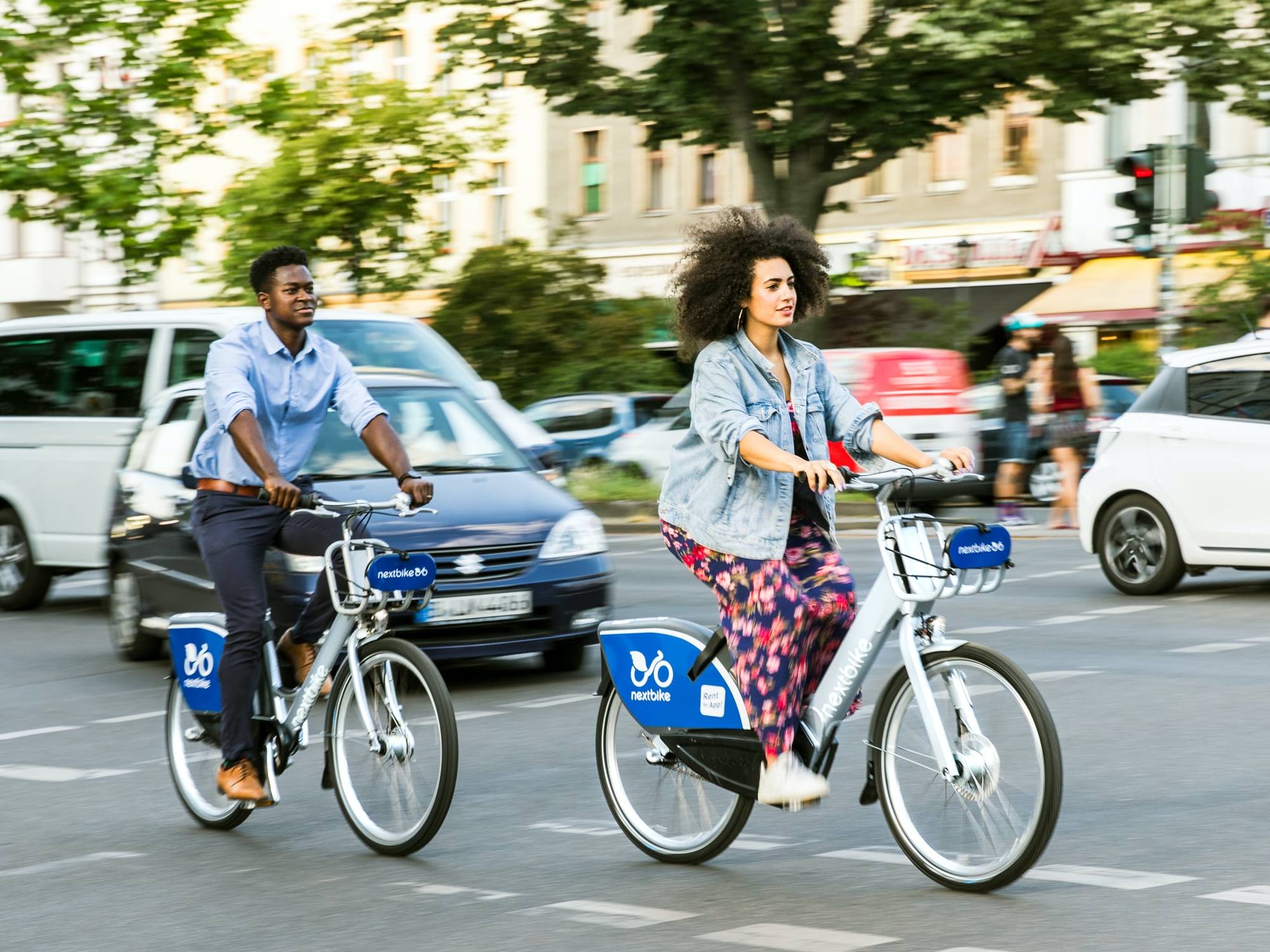 two people safely riding bikes in the city