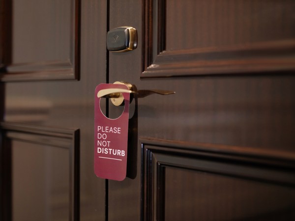 A do not disturb sign on a wooden door. It's the analog way to ensure you have notifications silenced.