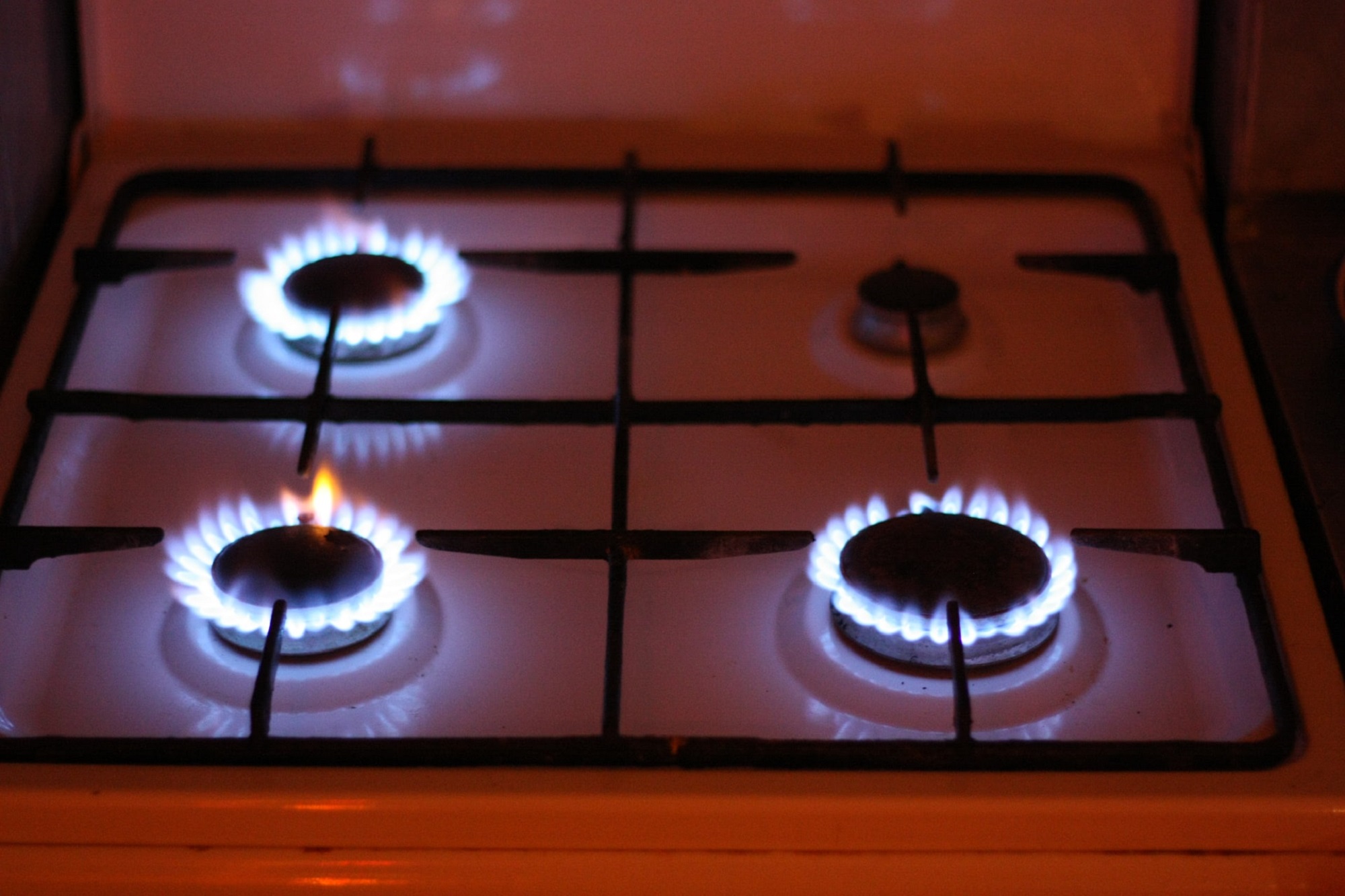 Gas stove with three burners on leaking methane