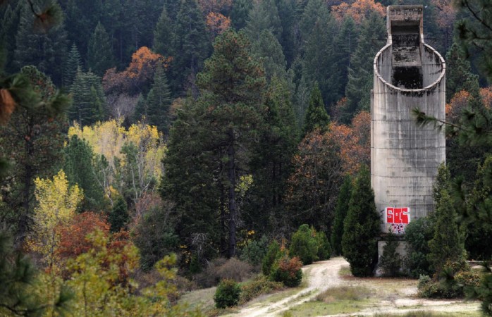 Old gold mining silo with graffiti in the California woods