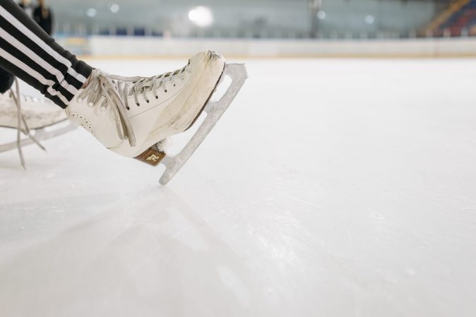 Figure skater's boots and blades on an ice rink