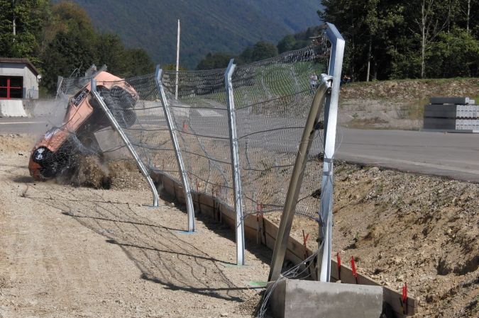 A race car crashes into a debris fence