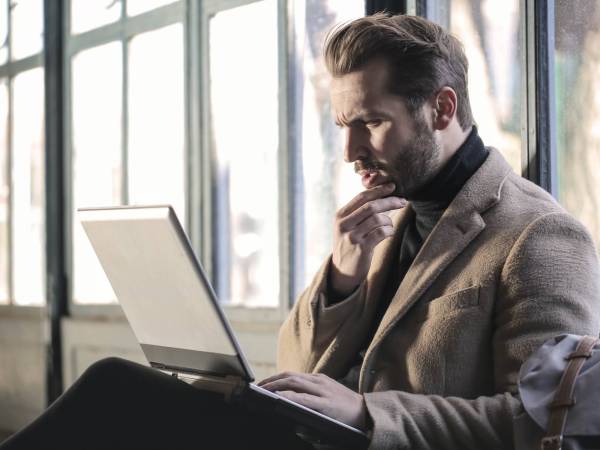 worried man looking at laptop screen