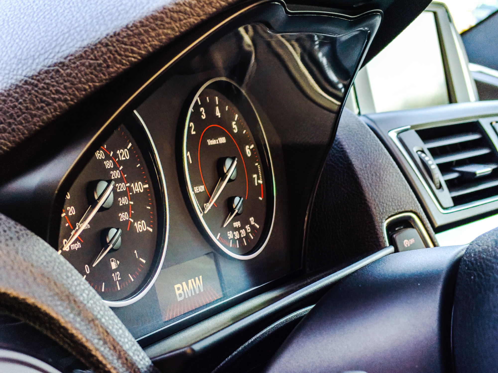 A car dashboard showing the gas tank on empty, and all the other dials at zero.