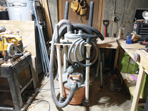 A DIY shop vac-mounted dust collector in a basement workshop.