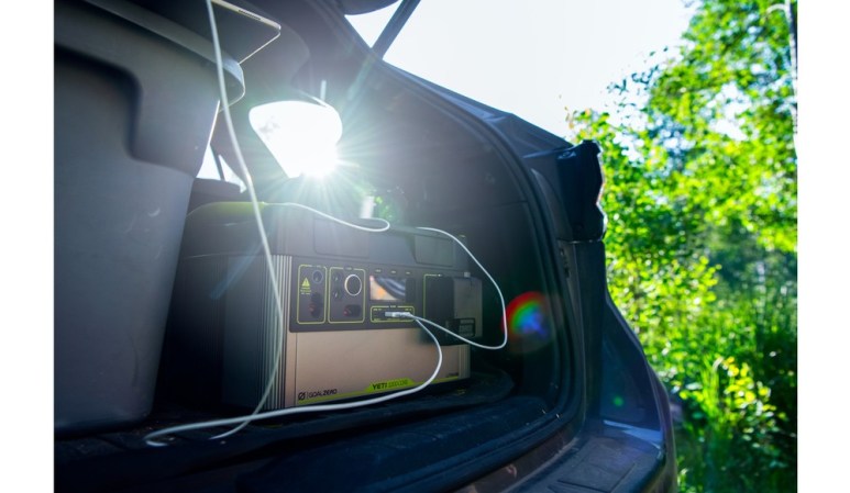 The Goal Zero Yeti 1000 Core in the back of a car powering a light