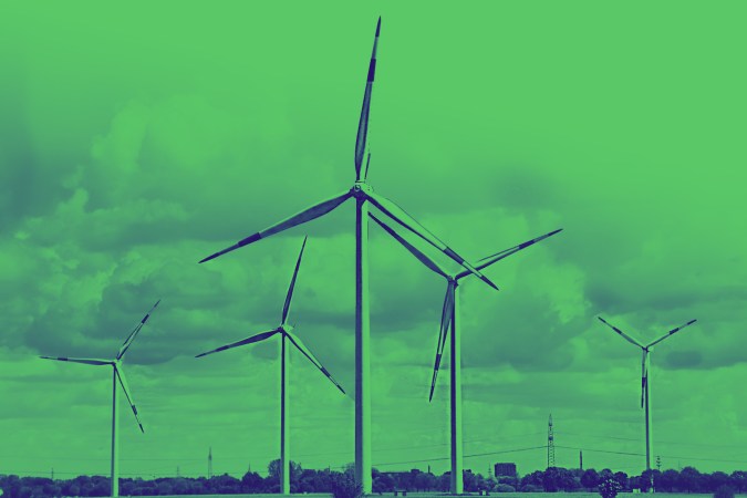 Wind turbines against a cloudy sky.