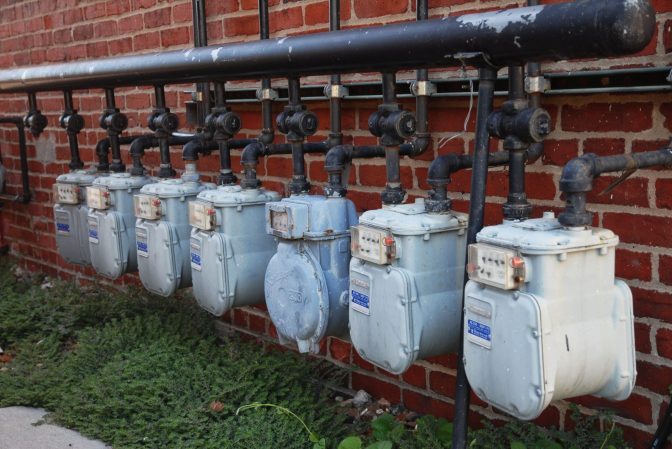 Gas meters on brick wall.