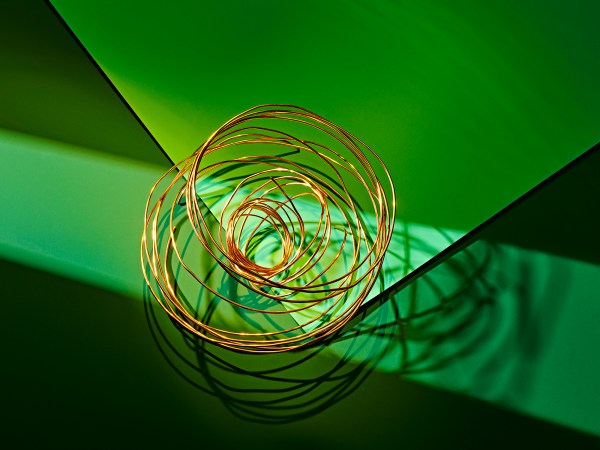 Ball of copper wire on green background