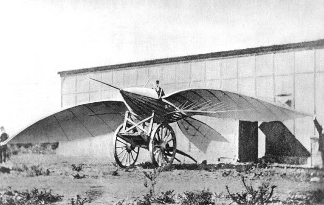 a bird-like flying craft attached to a wagon with a man in a top hat sitting in the cockpit