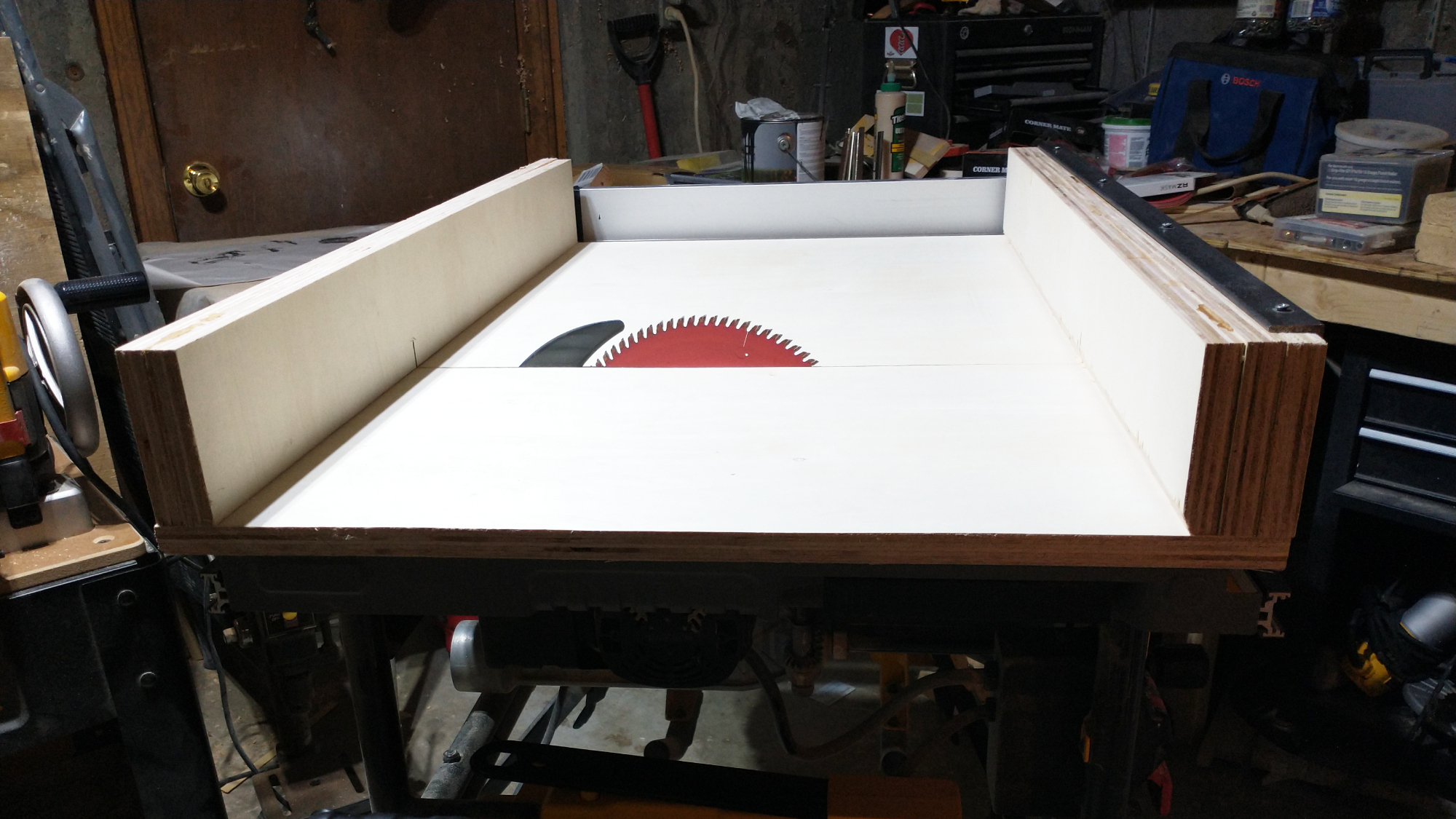 A DIY crosscut sled on a table saw in a woodworker's workshop.