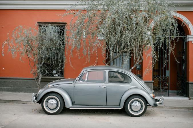 Vintage VW bug parked on the street.