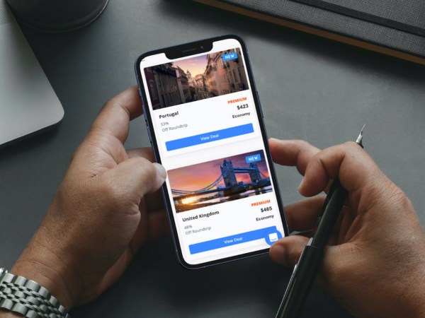 A photo of a person using a cellphone to book a flight