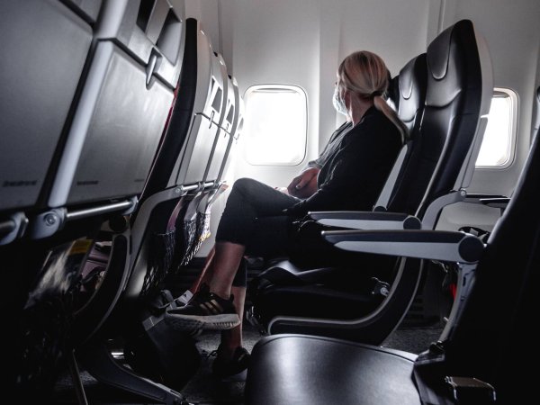 person sitting on airplane looking out the window