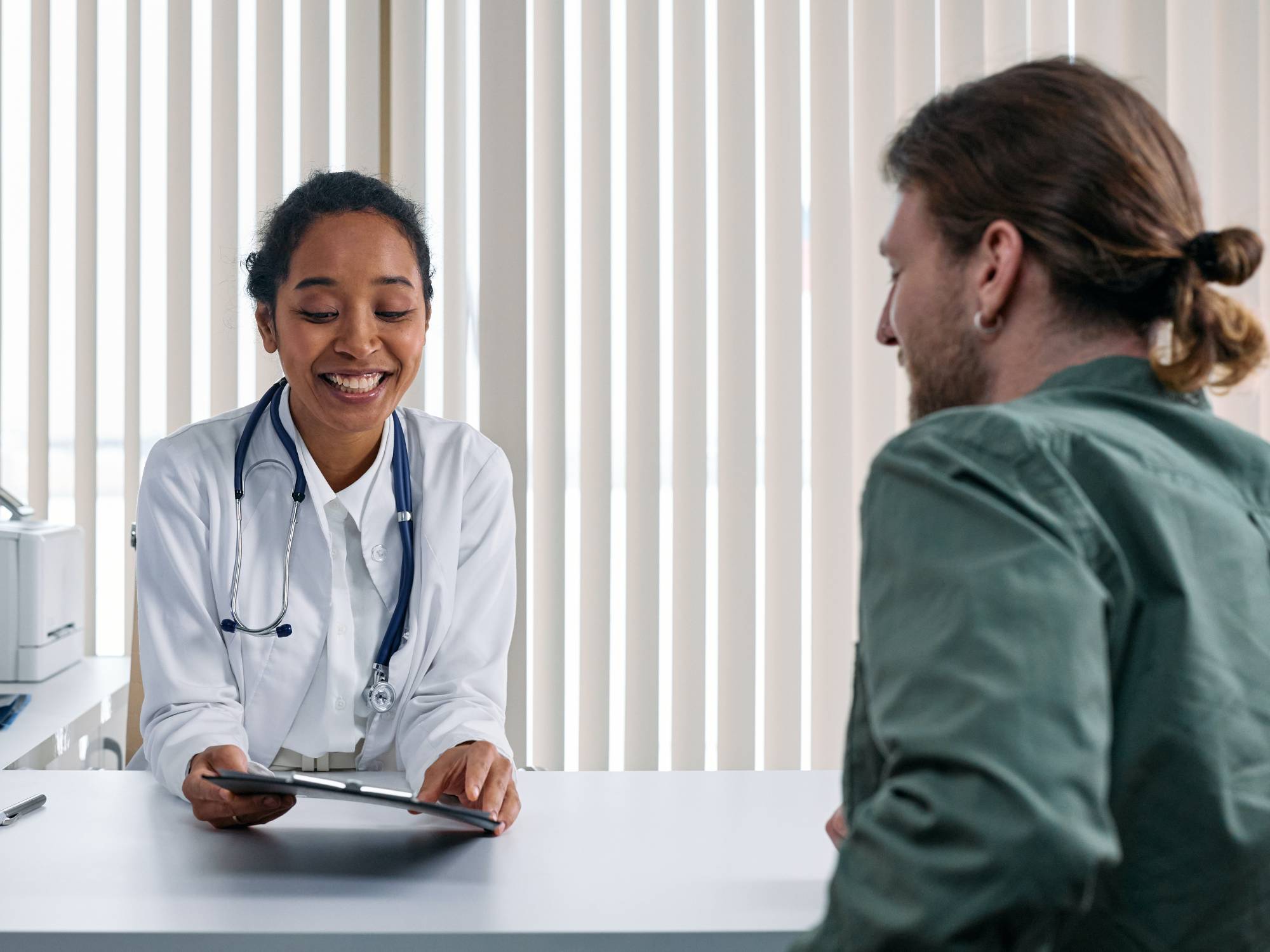 Doctor talking to patient in office