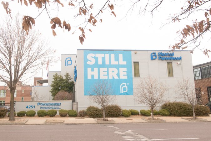 St. Louis Planned Parenthood, the last abortion clinic in Missouri and the defendants in Dobbs v. Jackson's Women's Health Organization, with a Still Here sign during the Roe v. Wade SCOTUS decision