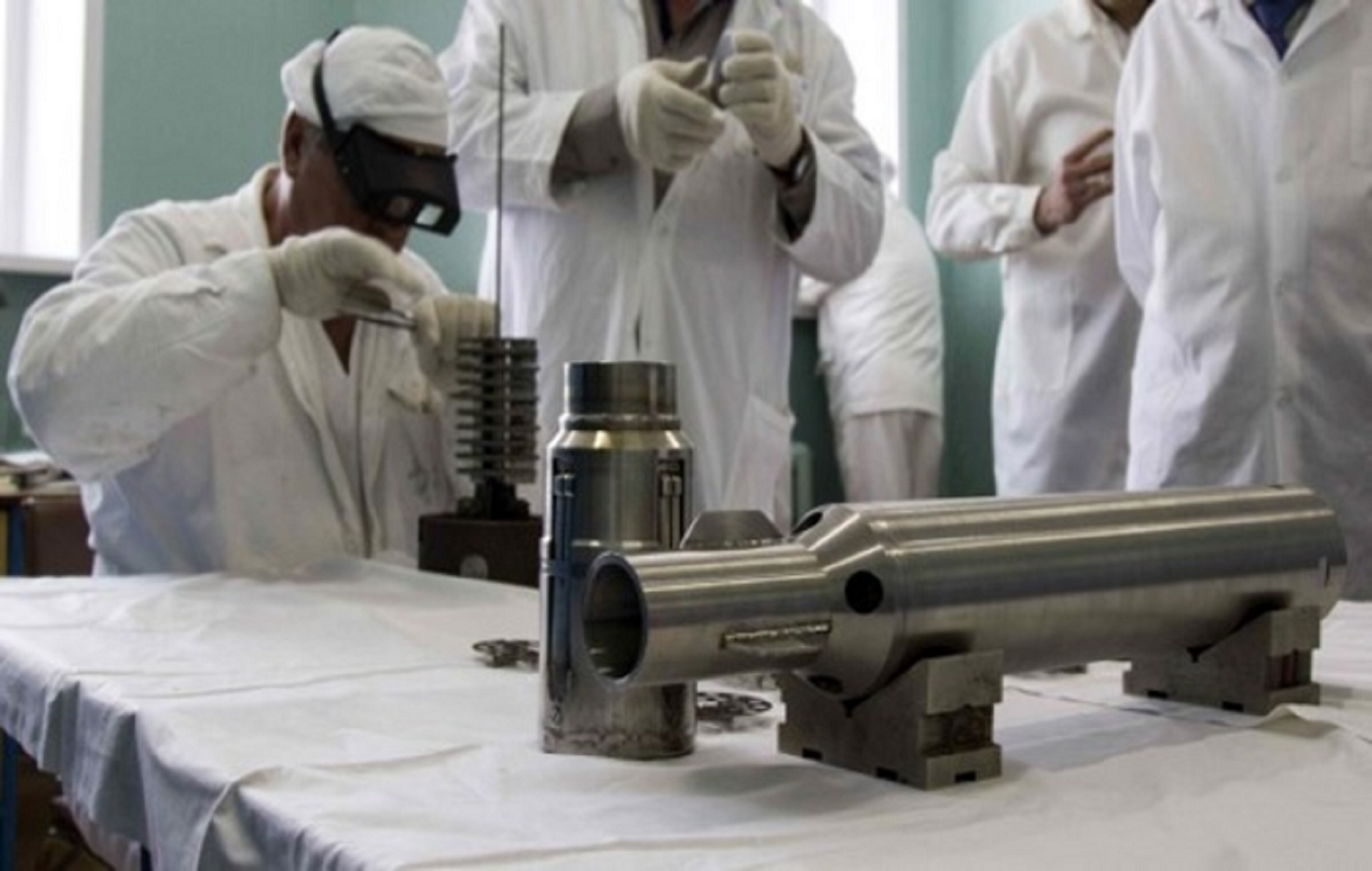 Department of Energy physicists handling chromium disks for a neutrino detector