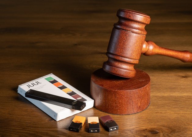 Juul e-cigarette vaping pen next to box and a gavel to symbolize FDA ban decision