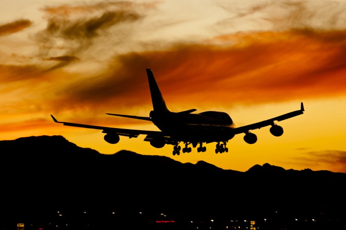 a 747 lands at sunset