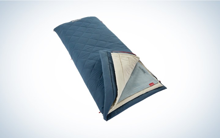  A Coleman All Weather Sleeping Bag against a blue and white gradient background