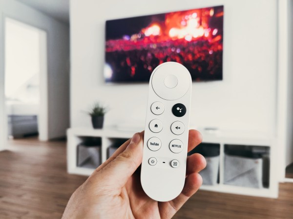 hand holding google chromecast remote