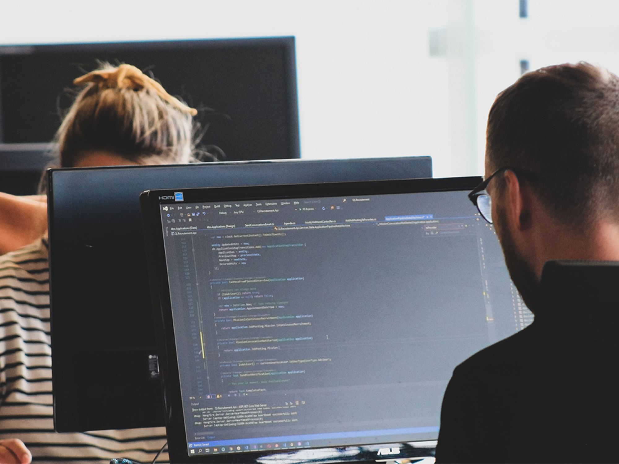 Two people coding at computers