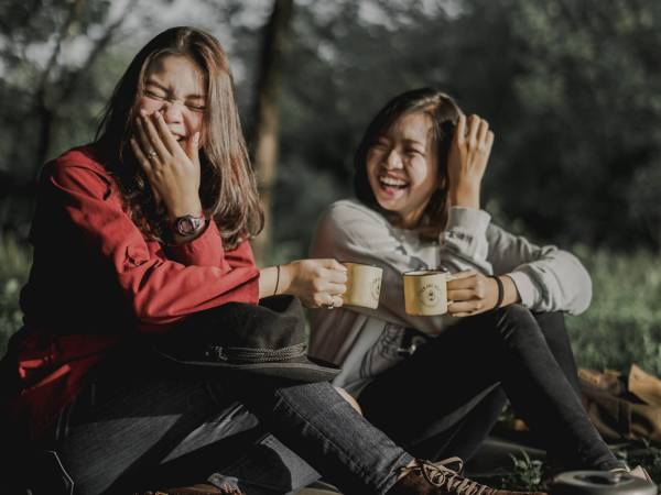 people laughing in the outdoors