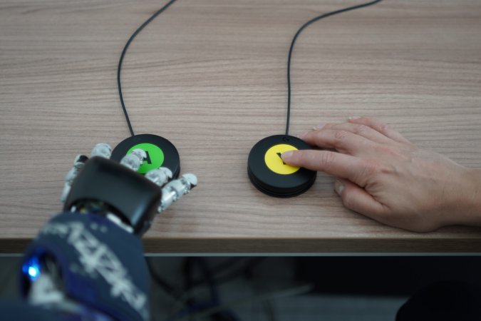 AI controlled robot and human pressing buttons