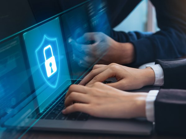 A person in a suit using a computer for cybersecurity