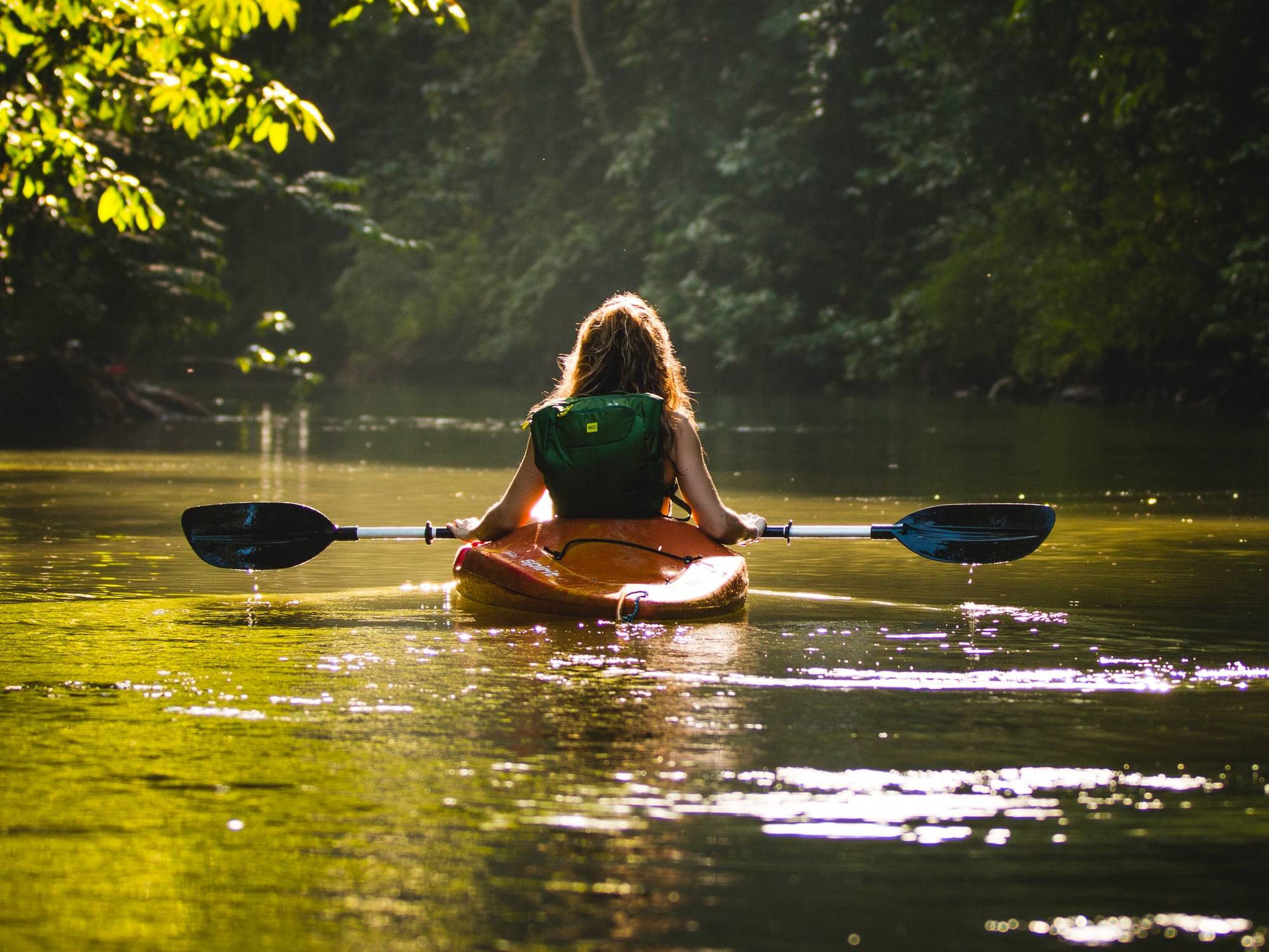 Person kayaking down a river