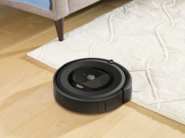 Roomba cleaning wood floor with rug.