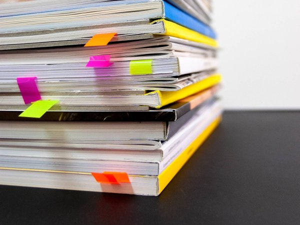 stack of magazines with page markers