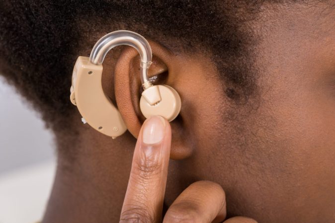 Close-up Of Woman Wearing Hearing Aid In Ear