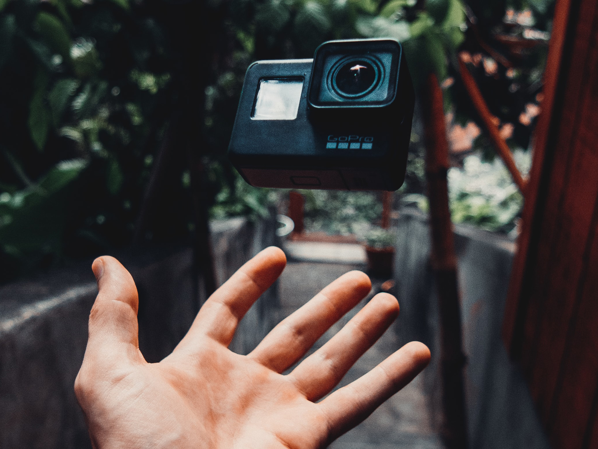 Hand under a go pro camera hanging in the air