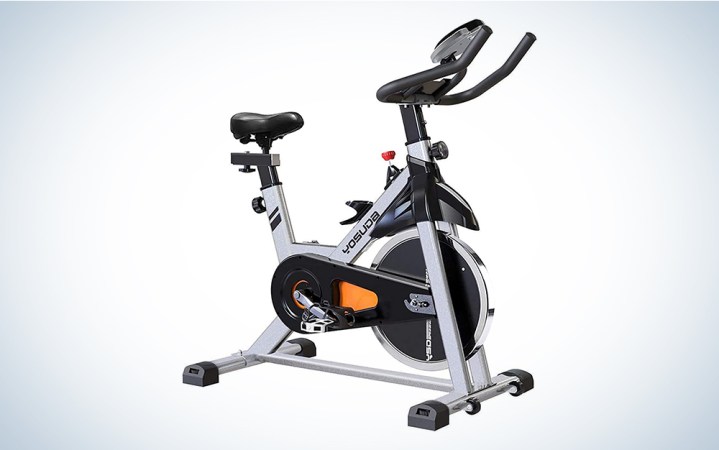  A Peloton-like spin bike on a blue and white gradient background