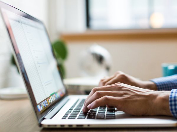 A person typing on a laptop