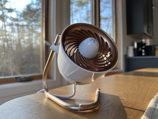 white and gold Vornado Pivot Personal Air Circulator Fan on a wooden table