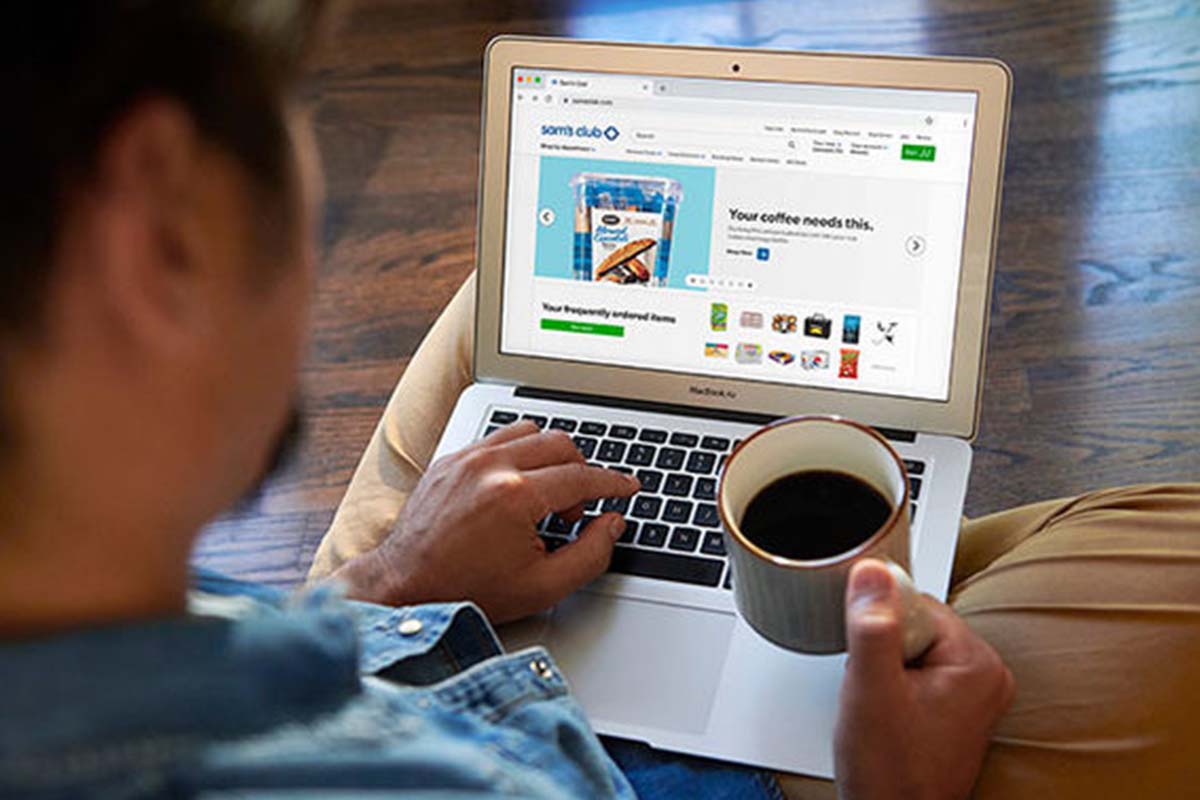 A person accesses the Sam's Club website on their laptop