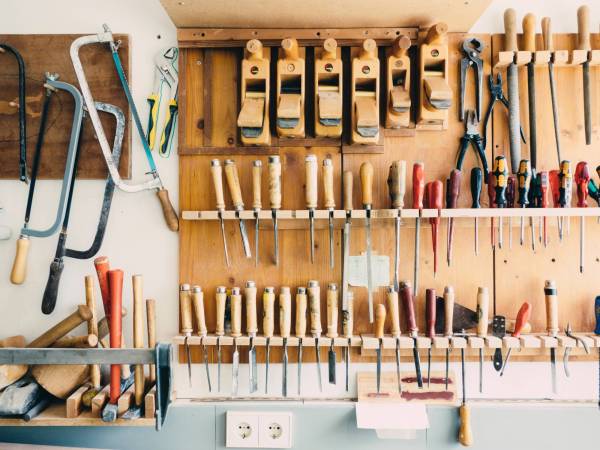 woodshop wall covered in hanging tools