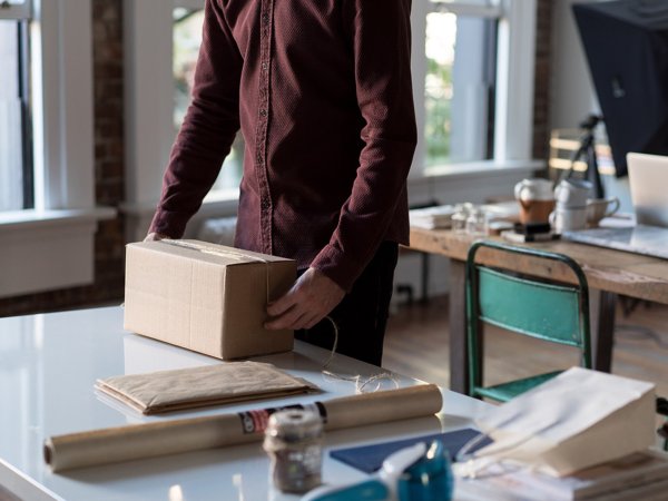 A person wrapping string around a box