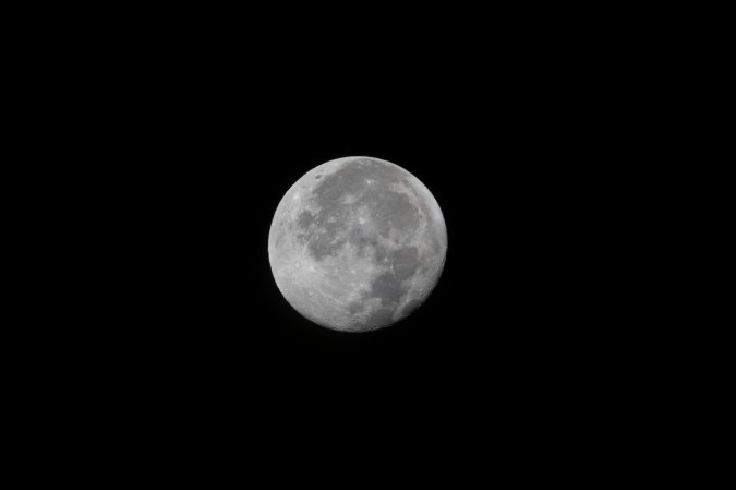 The moon rises above NASA's space center in Florida.