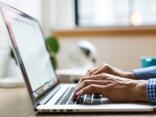 A person typing on a laptop