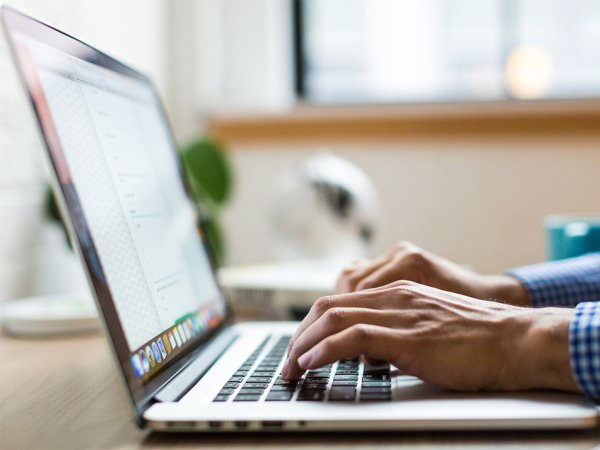 A person typing on a laptop