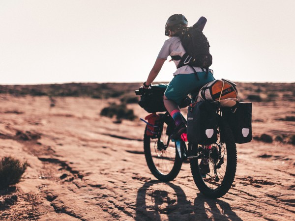 person-riding-a-fully-loaded bike in the desert