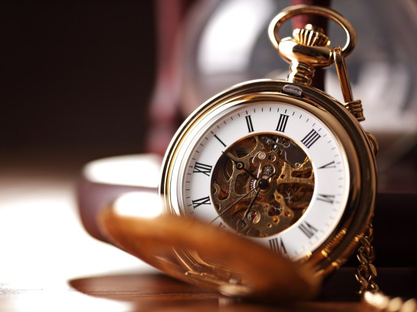 Gold pocket watch and hourglass